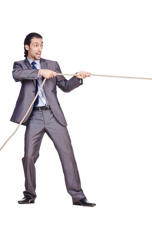 Businessman pulling rope on white