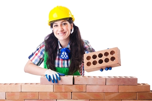 Woman builder with bricks on white