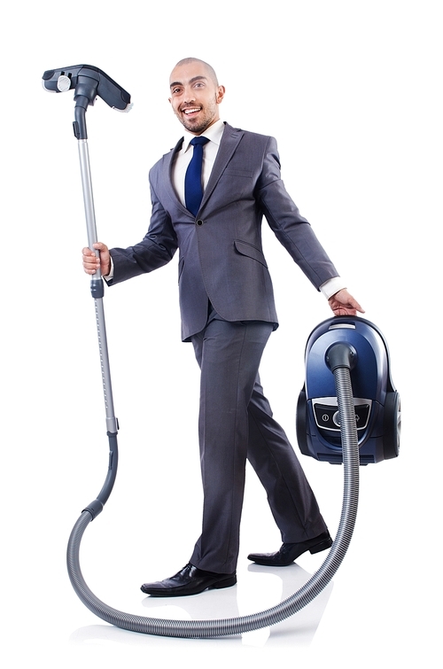 Businessman doing vacuum cleaning on white