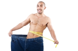 Man in dieting concept with oversized jeans