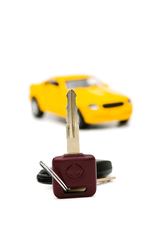 Car keys and car at background isolated on white