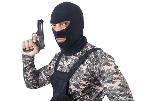 Soldier in camouflage with gun on white