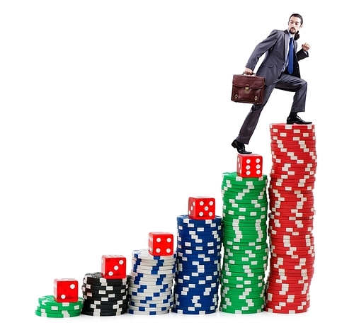 Businessman climbing stacks of casino chips