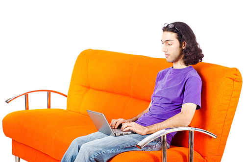 Student working with laptop sitting on sofa