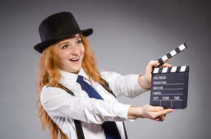 Young woman with movie board