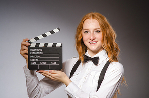 Young woman with movie board