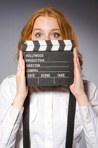 Young woman with movie board