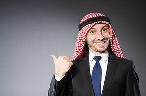 Arab businessman in delight against grey background