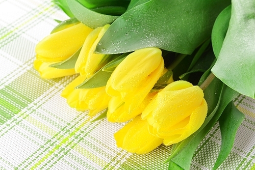 bouquet of fresh yellow tulips on table