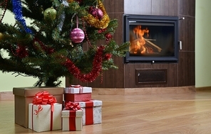 Christmas tree and christmas gift boxes in  interior with  fireplace