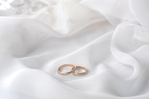White transparent  fabric and wedding rings close up