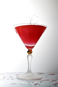 pouring liquid into cocktail glass