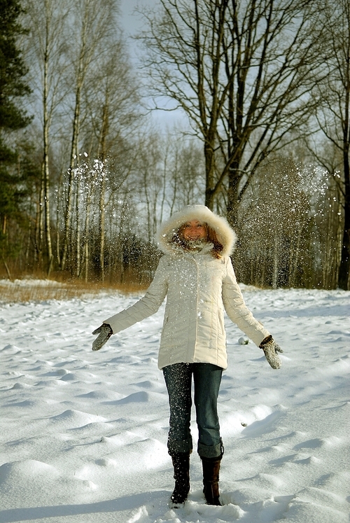 girl frowing snow sunny day