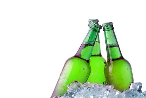 green bottles of beer chilling on ice