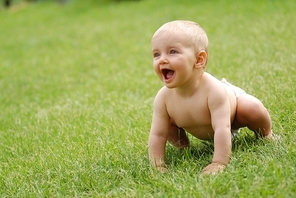 beautiful little girl on  green grass