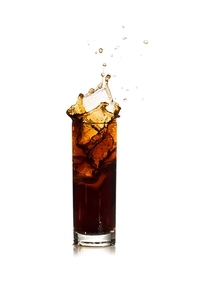 ice drops into cola with splashes