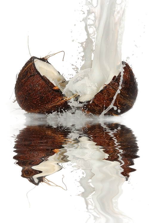 cracked coconut with big splash|isolated