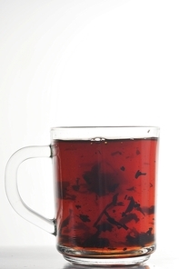Full glass cup of tea isolated