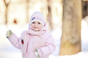 small beautiful girl playing in park.  winter day