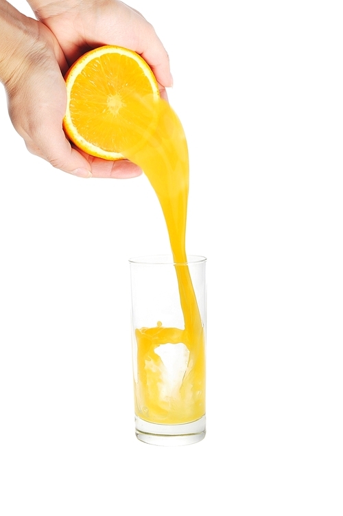 woman pour orange juice from cuted orange