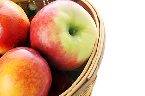 basket with different fruits on white background
