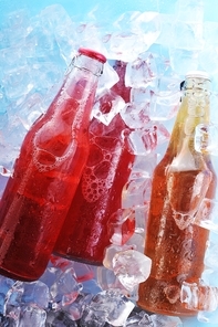 bottles with  tasty drink in ice