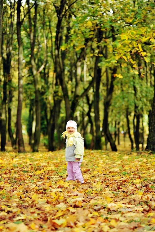 pretty girl playing in autumn park