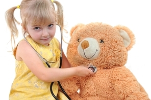 beautiful girl playing doctor and healing taddy bear
