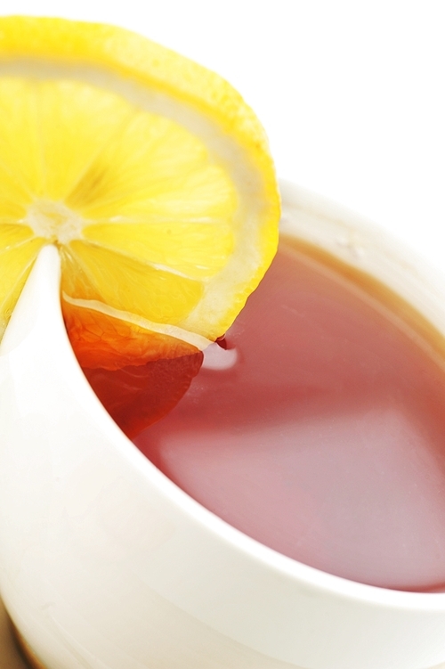 full cup of tea with lemon close up