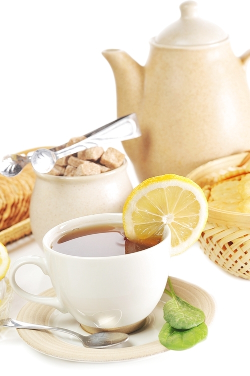 cup of tea with lemon  and  cookies in  basket