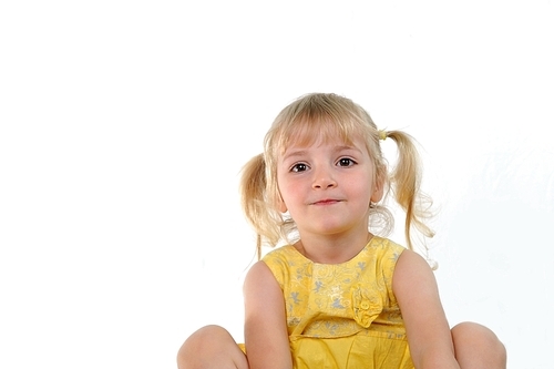 cheerful little girl sits on  couch in living room