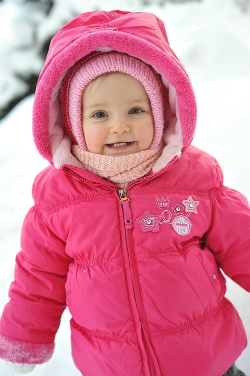 little girl in red jacket in winter