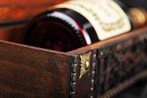 Cognac bottle in wooden case  background