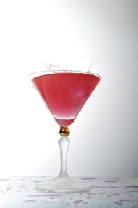 pouring liquid into cocktail glass