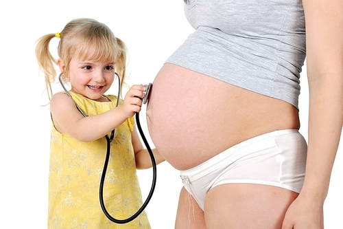 little girl  listening stethoscope  baby in  womb of her mother