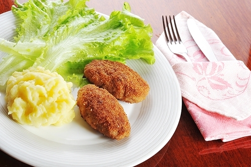 roasted cutlets of pork with potato and  lettuce