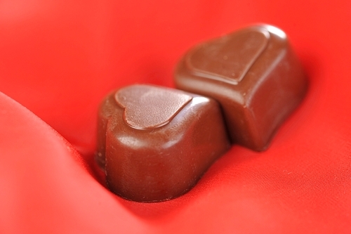 Tasty chocolate  on  red close up