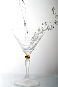 pouring liquid into cocktail glass
