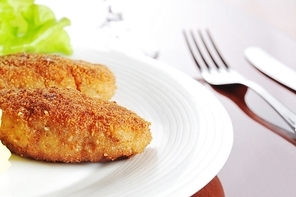 roasted cutlets of pork with potato and  lettuce
