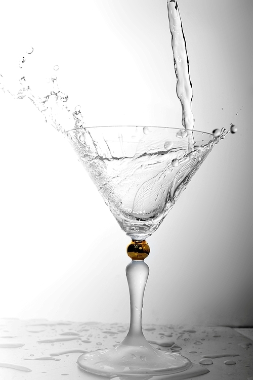 pouring liquid into cocktail glass