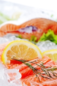 pieces of red fish and lemon  on ice