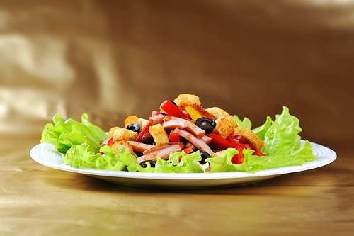 Fresh and tasty salad  on plate|golden background