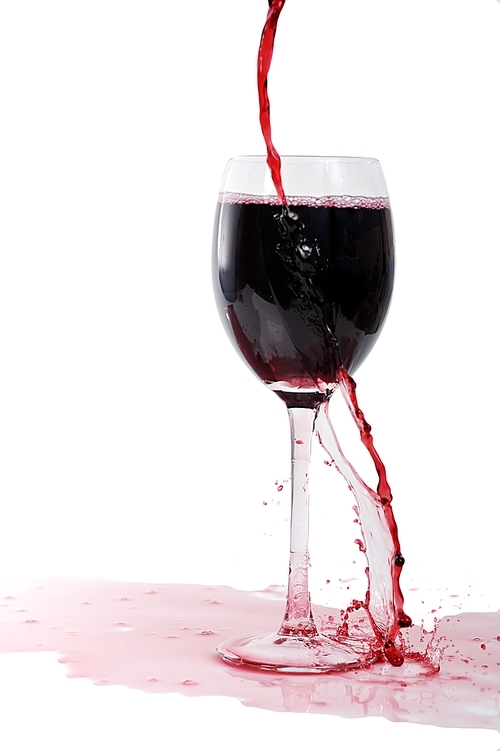 Red wine flows in glass