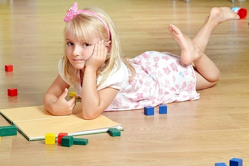 cute blond girl  playing  at home