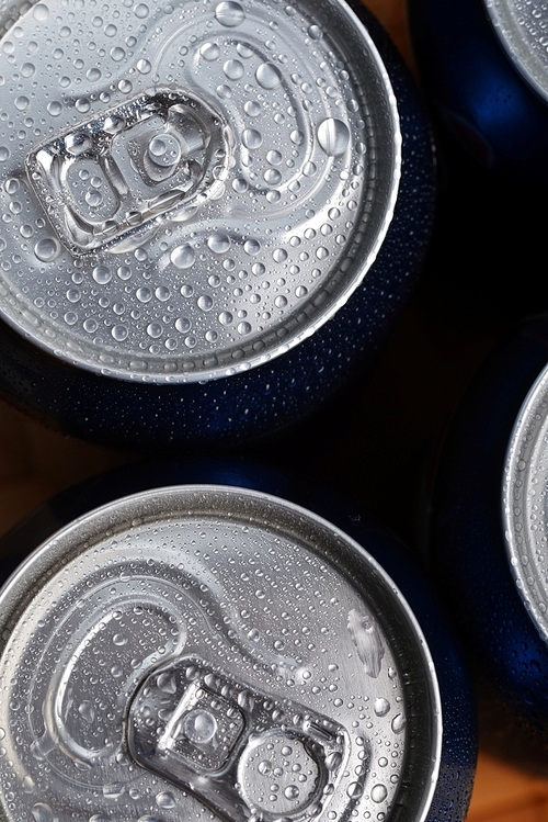 wet aluminium can with drink|close-up of top