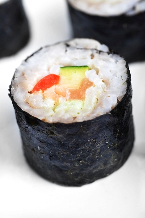 fresh sushi rolls  with salmon on white background