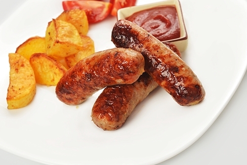 grilled meat sausages with potatoes and tomatoes