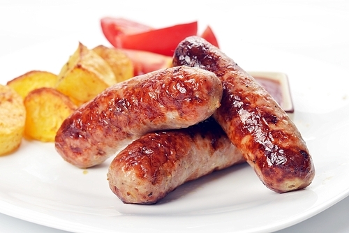 grilled meat sausages with potatoes and tomatoes