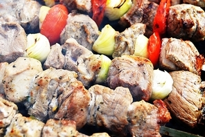 Barbecue with delicious grilled meat  and onions on grill