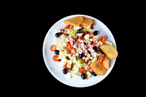 fresh chopped ham salad with cheese on  black background